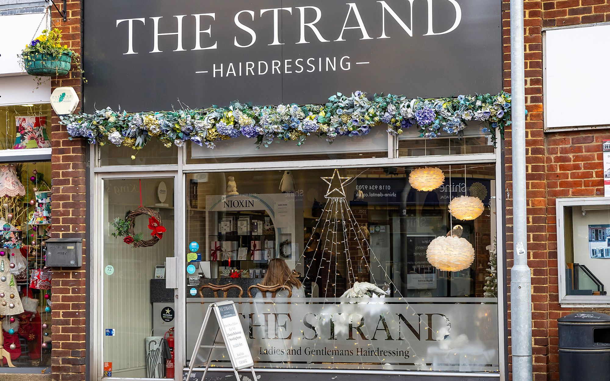 Christmas window display of The Strand Hairdressing