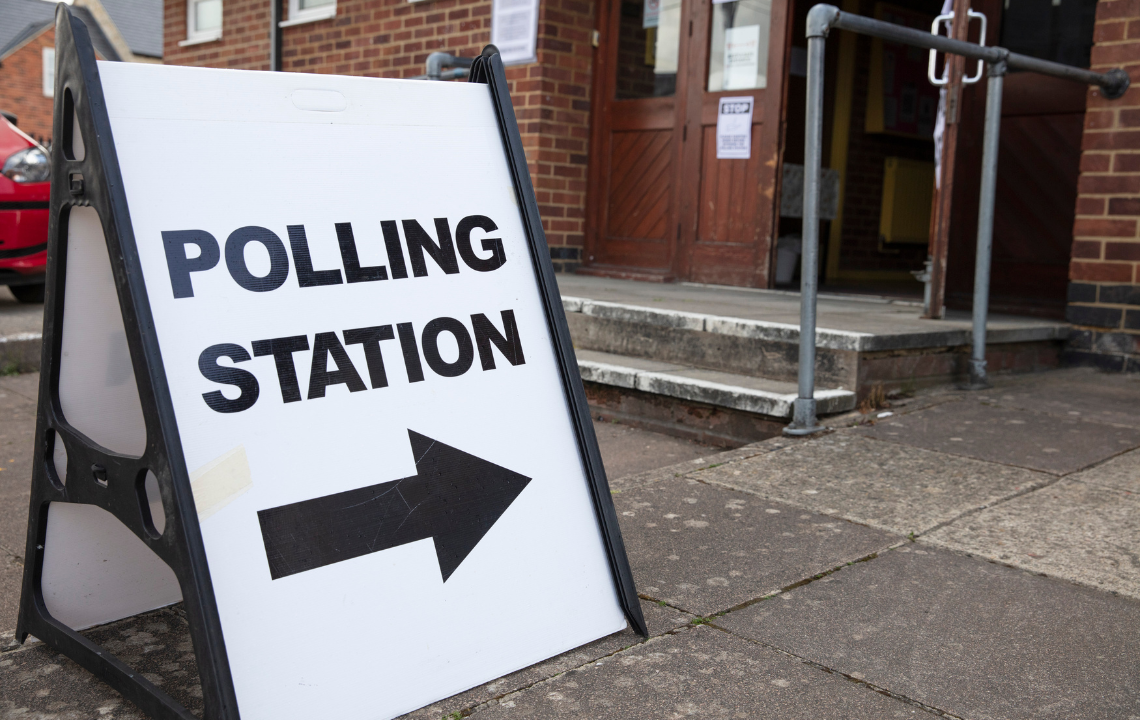 A sign pointing to a polling station