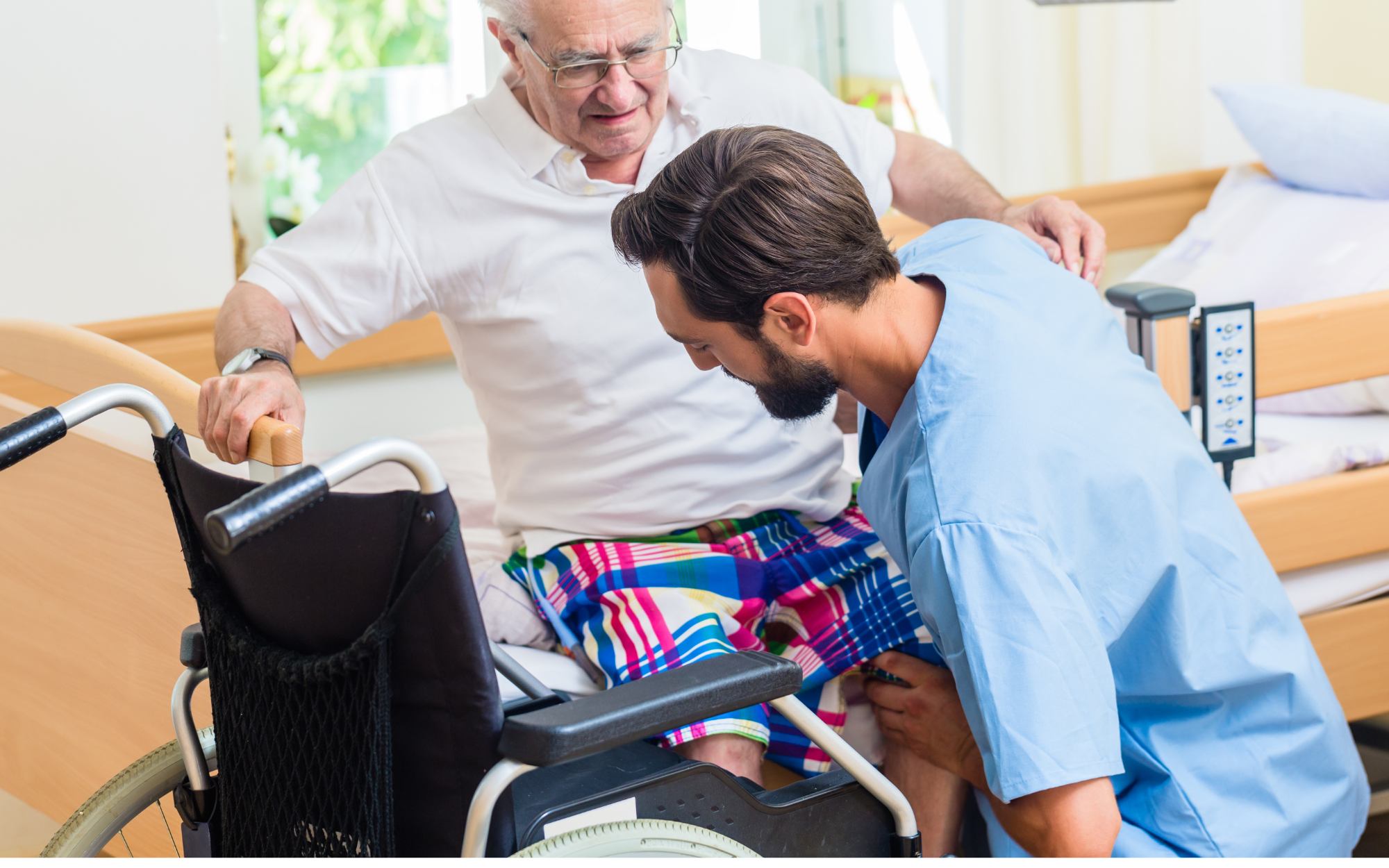 A care worker helping an older man into a wheelchair