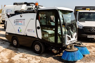 a photo of a street sweeping vehicle with Wokingham Borough Council and partner logos on the side