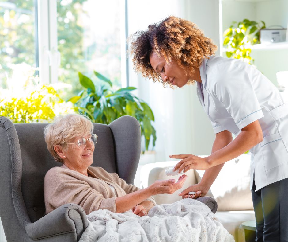 A social care worker helping a woman in a chair