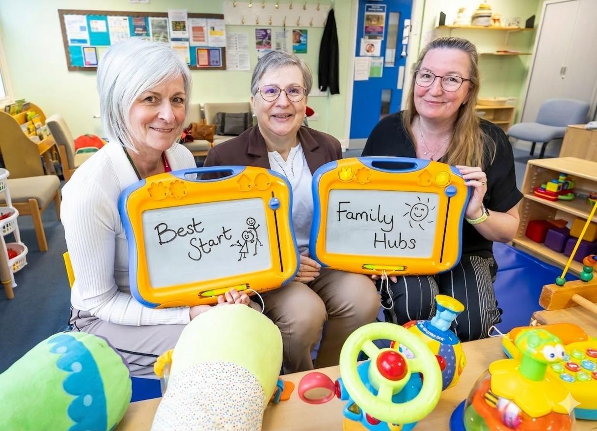 Photo of three women in the Ambleside Family Hub, sitting among brightly coloured toys