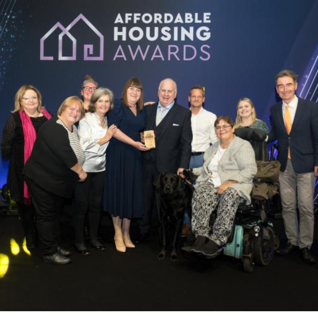 Group of tenants and council representatives collecting tenants award