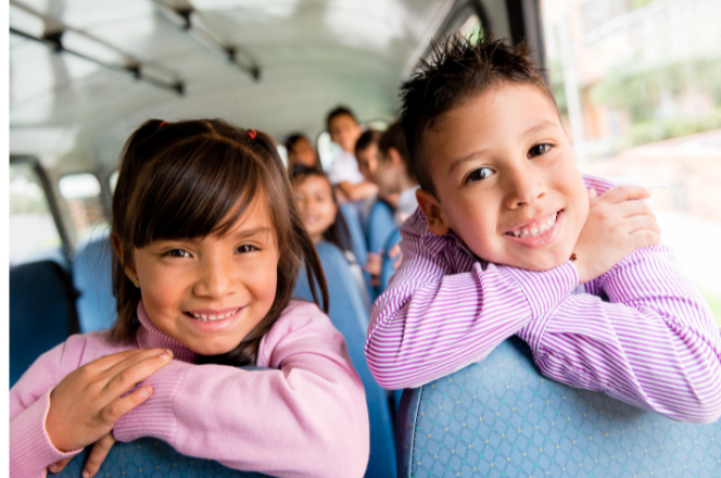 Two school children on a bus