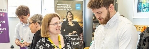 A man speaking to an employer at a stall