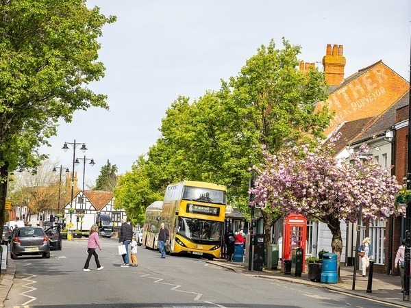 People crossing the road near a bus in Wokingham town